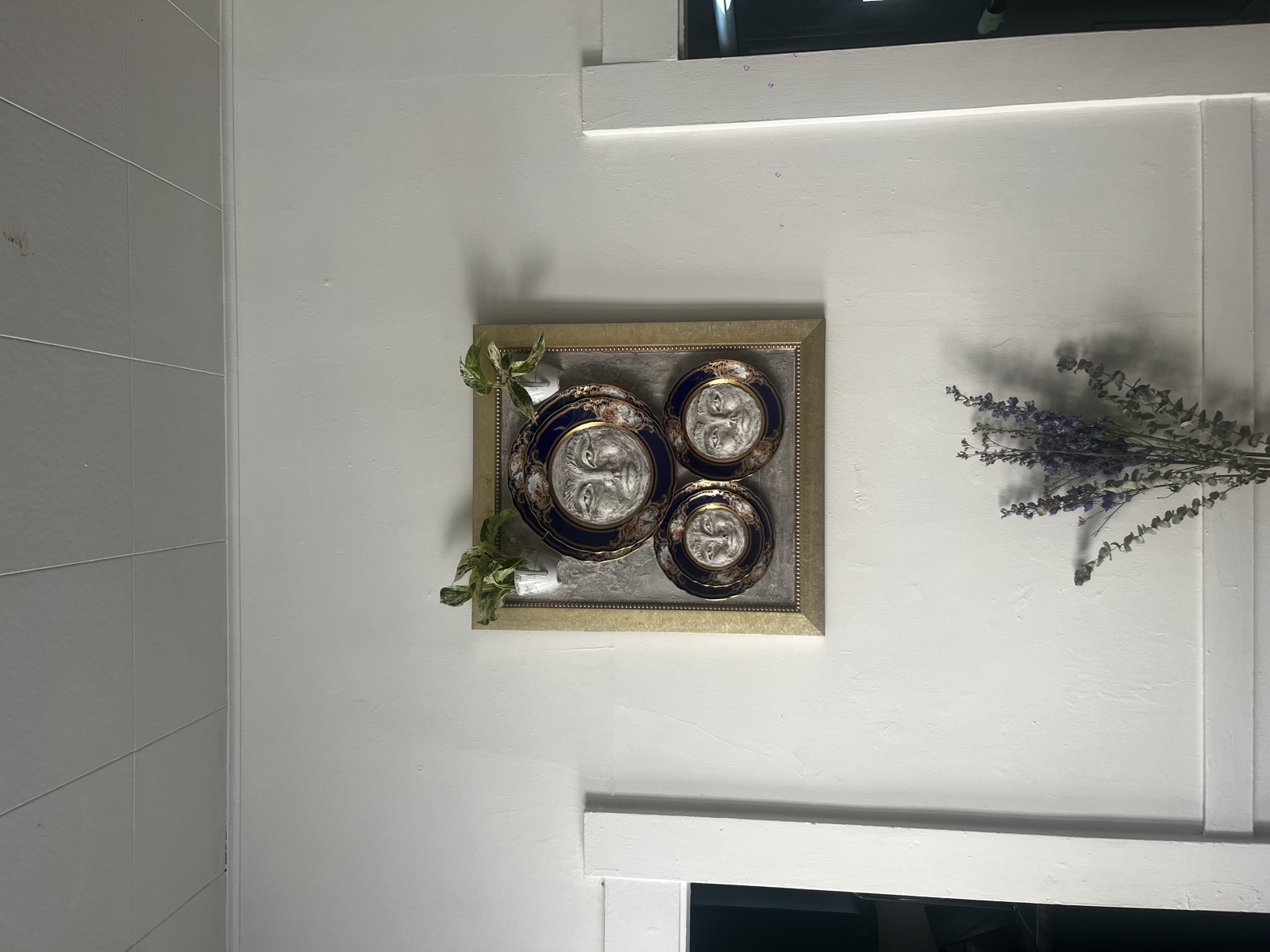 Work by Chelsea Wright hanging in a home, with lavender below